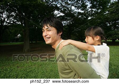 Girl riding piggyback on her father View Large Photo Image Stock Photo - Girl riding piggyback on her father. Fotosearch