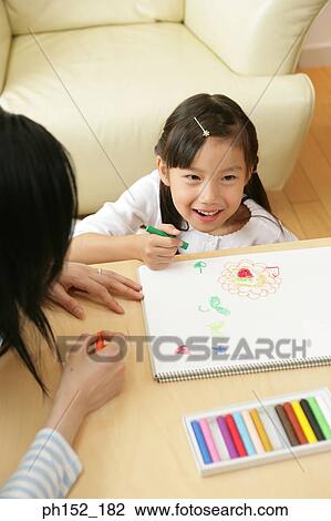 Girl sitting with her mother and drawing View Large Photo Image Stock Image - Girl sitting with her mother and drawing. Fotosearch