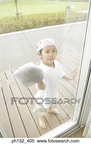 Stock Photography - High angle view of a boy cleaning a window. Fotosearch
