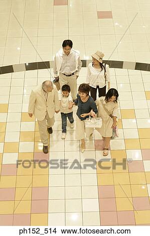 High angle view of a family walking in a shopping mall View Large Photo Image Picture - High angle view of a family walking in a shopping mall. Fotosearch