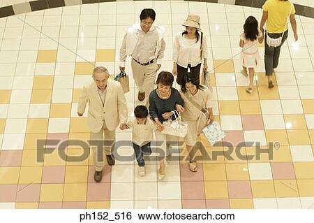 High angle view of a three generation family walking in a shopping mall View Large Photo Image Stock Photograph - High angle view of a three generation family walking in a shopping mall. Fotosearch