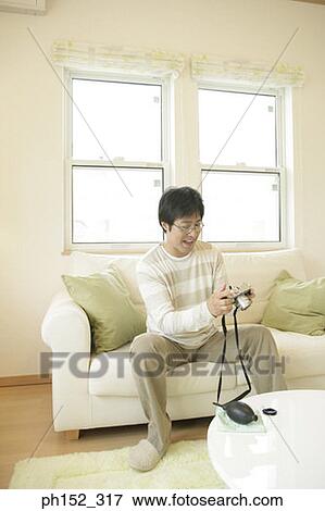 Mature man holding a camera and smiling View Large Photo Image Stock Photo - Mature man holding a camera and smiling. Fotosearch