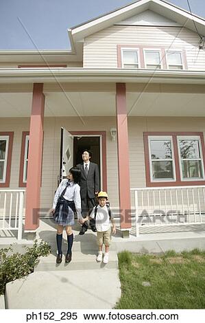 Mature man stepping out of the house with his son and daughter View Large Photo Image Stock Photography - Mature man stepping out of the house with his son and daughter. Fotosearch