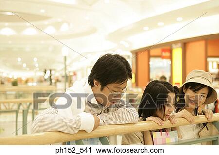 Mid adult couple and their daughter in a shopping mall View Large Photo Image Stock Image - Mid adult couple and their daughter in a shopping mall. Fotosearch