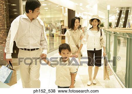 Mid adult couple with their son and daughter in a shopping mall View Large Photo Image Stock Photo - Mid adult couple with their son and daughter in a shopping mall. Fotosearch