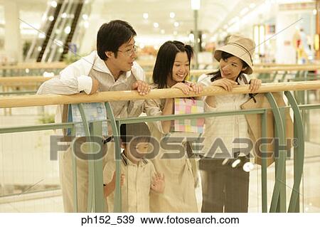 Mid adult couple with their son and daughter in a shopping mall View Large Photo Image Stock Photo - Mid adult couple with their son and daughter in a shopping mall. Fotosearch