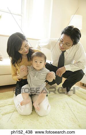 Stock Photo - Mid adult couple with their son. Fotosearch