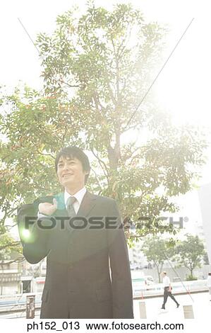 Mid adult man carrying a hand bag and smiling View Large Photo Image Stock Image - Mid adult man carrying a hand bag and smiling. Fotosearch