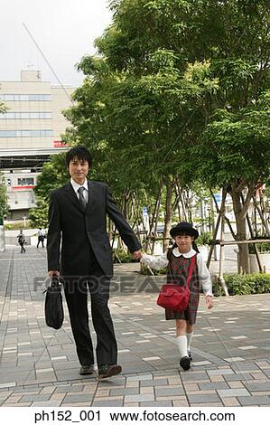 Mid adult man holding his daughter's hand and walking View Large Photo Image Stock Image - Mid adult man holding his daughter's hand and walking. Fotosearch