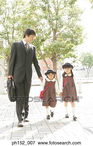 Mid adult man holding his daughter's hand and walking View Large Photo Image Stock Photo - Mid adult man holding his daughter's hand and walking. Fotosearch