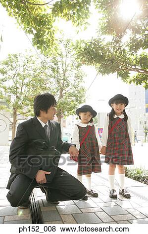 Mid adult man holding his daughter's hand View Large Photo Image Stock Photo - Mid adult man holding his daughter's hand. Fotosearch