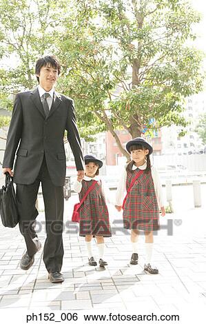 Mid adult man holding his daughter's hand and walking View Large Photo Image Stock Photograph - Mid adult man holding his daughter's hand and walking. Fotosearch