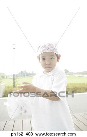 Stock Photo - Portrait of a boy cleaning a window. Fotosearch