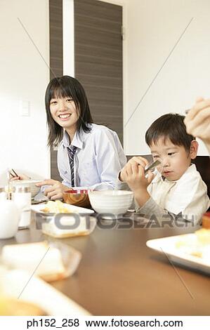 Portrait of a girl and her brother at the dining table View Large Photo Image Stock Photo - Portrait of a girl and her brother at the dining table. Fotosearch