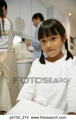 Portrait of a girl carrying a stack of folded towels View Large Photo Image Picture - Portrait of a girl carrying a stack of folded towels. Fotosearch