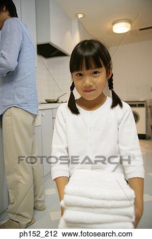 Portrait of a girl carrying a stack of folded towels View Large Photo Image Stock Image - Portrait of a girl carrying a stack of folded towels. Fotosearch