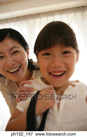 Portrait of a mid adult woman and her daughter smiling View Large Photo Image Stock Photo - Portrait of a mid adult woman and her daughter smiling. Fotosearch
