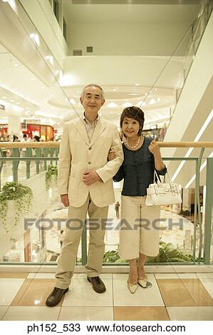 Portrait of a senior couple smiling in a shopping mall View Large Photo Image Stock Image - Portrait of a senior couple smiling in a shopping mall. Fotosearch