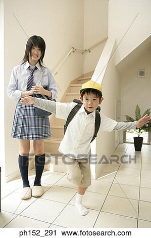 Portrait of a teenage girl smiling with her brother standing on a leg View Large Photo Image Stock Image - Portrait of a teenage girl smiling with her brother standing on a leg. Fotosearch