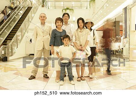 Stock Image - Portrait of a three generation family standing in a shopping mall. Fotosearch