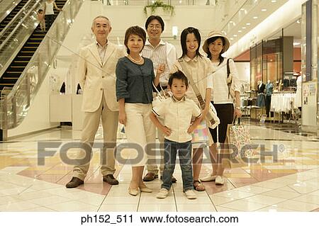 Portrait of a three generation family standing in a shopping mall View Large Photo Image Stock Image - Portrait of a three generation family standing in a shopping mall. Fotosearch