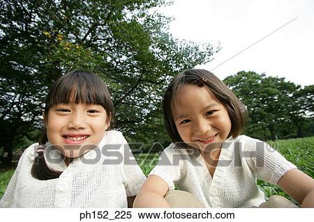 Portrait of two girls smiling View Large Photo Image Stock Photography - Portrait of two girls smiling. Fotosearch