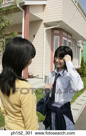Rear view of a mature woman standing with her daughter View Large Photo Image Stock Image - Rear view of a mature woman standing with her daughter. Fotosearch