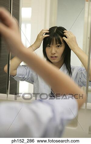 Reflection of a teenage girl in a mirror View Large Photo Image Stock Photograph - Reflection of a teenage girl in a mirror. Fotosearch