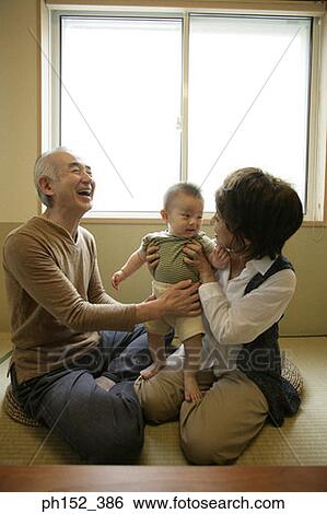 Stock Photograph - Senior couple with their grandson. Fotosearch