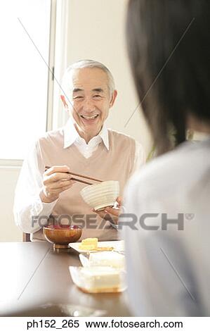 Senior man holding a bowl and a pair of chopsticks View Large Photo Image Stock Photography - Senior man holding a bowl and a pair of chopsticks. Fotosearch