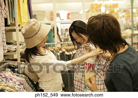 Senior woman with her daughter and granddaughter in a clothing store View Large Photo Image Stock Photo - Senior woman with her daughter and granddaughter in a clothing store. Fotosearch