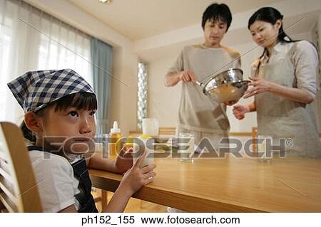 Side profile of a girl sitting at the table and drinking milk with her parents in the background View Large Photo Image Stock Photography - Side profile of a girl sitting at the table and drinking milk with her parents in the background. Fotosearch