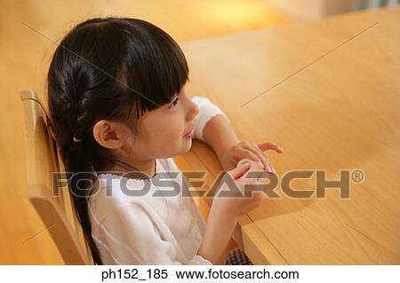 Side profile of a girl sitting at the table View Large Photo Image Stock Photography - Side profile of a girl sitting at the table. Fotosearch