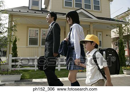 Side profile of a mature man walking with his son and daughter on the road View Large Photo Image Stock Photograph - Side profile of a mature man walking with his son and daughter on the road. Fotosearch