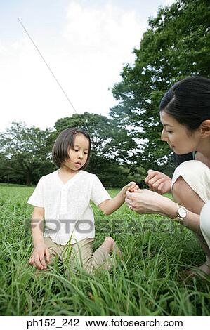 Side profile of a mid adult woman and her daughter playing in the park View Large Photo Image Stock Image - Side profile of a mid adult woman and her daughter playing in the park. Fotosearch