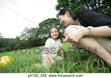 Side profile of a mid adult woman and her daughter in the park View Large Photo Image Stock Photography - Side profile of a mid adult woman and her daughter in the park. Fotosearch