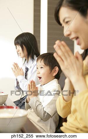 Side profile of a mid adult woman with her son and daughter praying at the dining table View Large Photo Image Stock Photography - Side profile of a mid adult woman with her son and daughter praying at the dining table. Fotosearch