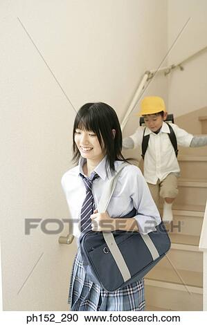 Teenage girl and her brother walking down an staircase View Large Photo Image Stock Image - Teenage girl and her brother walking down an staircase. Fotosearch