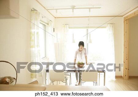 Young woman cleaning the table and smiling View Large Photo Image Stock Image - Young woman cleaning the table and smiling. Fotosearch