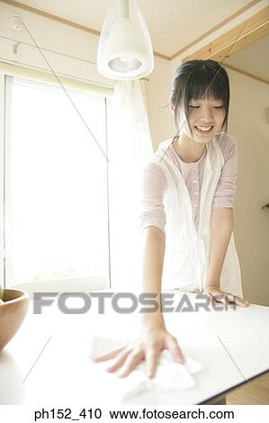 Young woman cleaning the table View Large Photo Image Stock Image - Young woman cleaning the table. Fotosearch