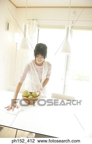 Young woman cleaning the table View Large Photo Image Stock Image - Young woman cleaning the table. Fotosearch