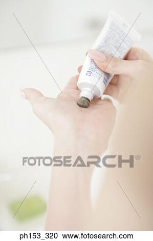 Close-up of a woman's hand squeezing a tube on her palm View Large Photo Image Stock Image - Close-up of a woman's hand squeezing a tube on her palm. Fotosearch