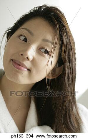 Close-up of a young woman drying her hair with a towel View Large Photo Image Picture - Close-up of a young woman drying her hair with a towel. Fotosearch