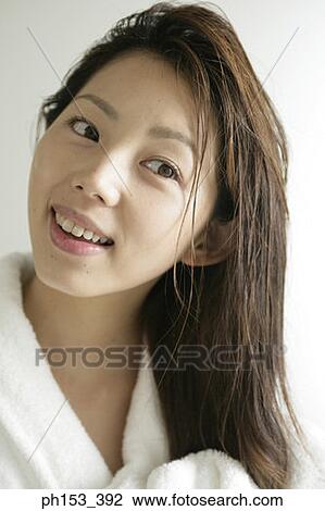 Close-up of a young woman drying her hair with a towel View Large Photo Image Stock Image - Close-up of a young woman drying her hair with a towel. Fotosearch