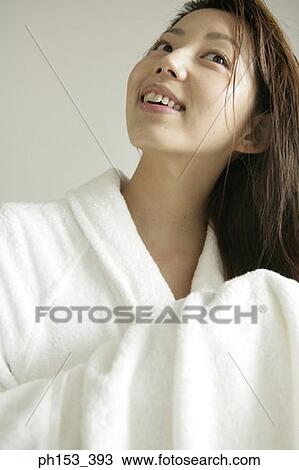 Close-up of a young woman drying her hair with a towel View Large Photo Image Stock Image - Close-up of a young woman drying her hair with a towel. Fotosearch