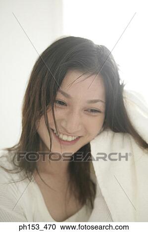 Close-up of a young woman drying her hair with a towel View Large Photo Image Stock Image - Close-up of a young woman drying her hair with a towel. Fotosearch