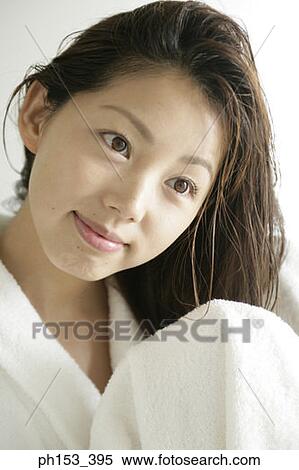 Close-up of a young woman drying her hair with a towel View Large Photo Image Stock Photography - Close-up of a young woman drying her hair with a towel. Fotosearch
