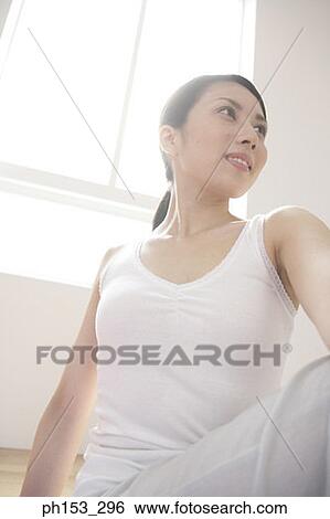 Close-up of a young woman exercising View Large Photo Image Stock Photograph - Close-up of a young woman exercising. Fotosearch