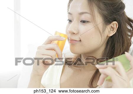 Close-up of a young woman holding two bars of soap View Large Photo Image Picture - Close-up of a young woman holding two bars of soap. Fotosearch
