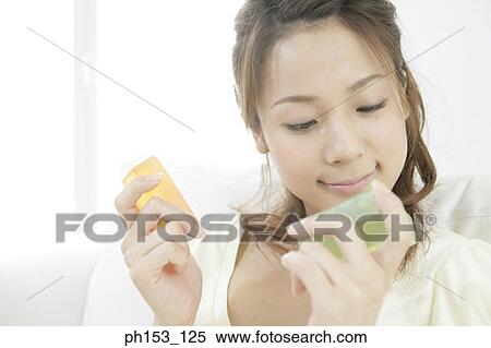Close-up of a young woman holding two bars of soap View Large Photo Image Stock Photography - Close-up of a young woman holding two bars of soap. Fotosearch